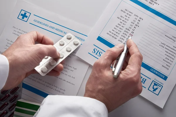 Doctor prescribing drugs and showing blood test report top view