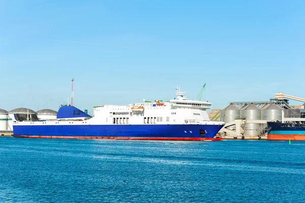 Modern blue cargo ship in Lithuanian harbor of Klaipeda