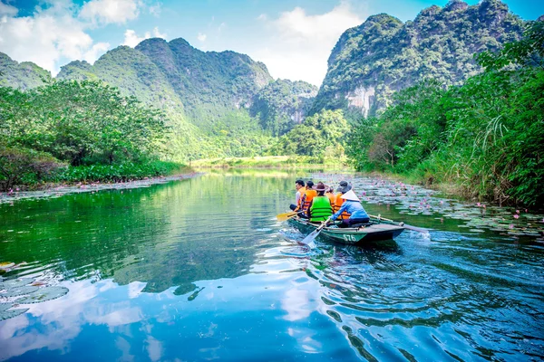 TRANGAN ECO-TOURIST COMPLEX, VIETNAM - NOVEMBER 27, 2014 - Tourists travelling by boat on the stream of the Complex.