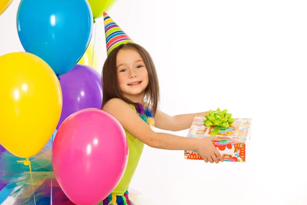 Little girl with gift box and colorful balloons on birthday party