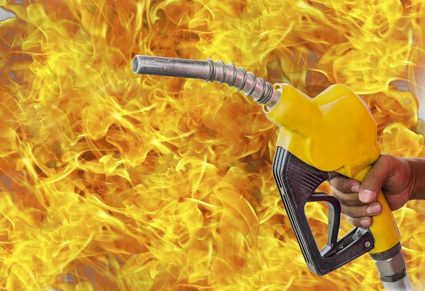 Holding a fuel nozzle against white flame background.