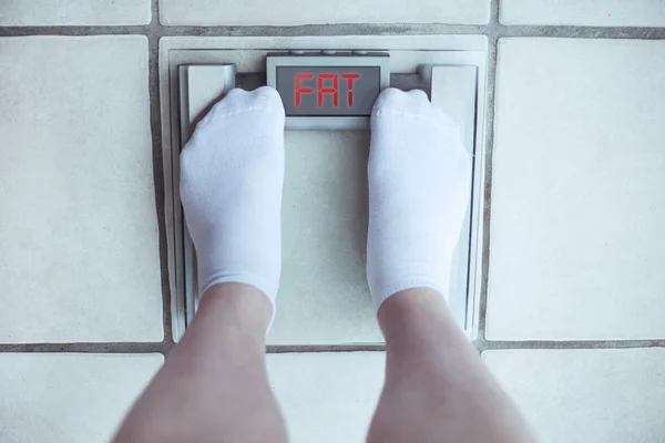 Woman\'s feet on bathroom scale. Diet concept