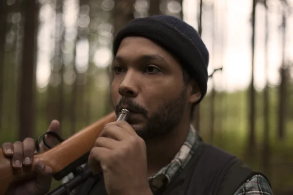 Interracial hunter blowing a whistle