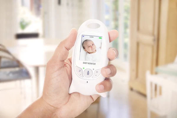 Hand holding baby monitor device