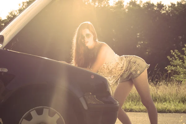 Sexy redhead woman hitchhiking