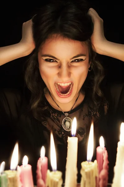 Screaming woman with candles