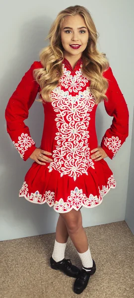 Girl doing Irish dance in red