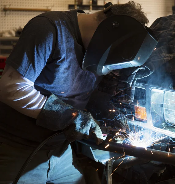 Man welding the bumper of a vehicle