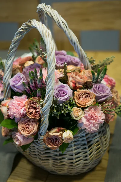 Beautiful roses in wicker basket