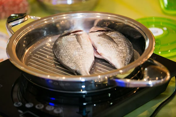 Fish cooking in pan