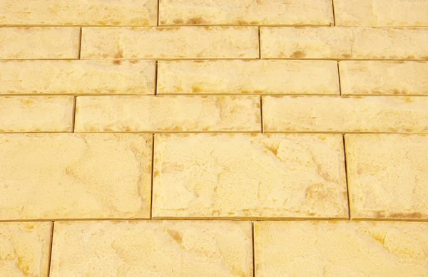 Yellow cladding tiles imitating stones