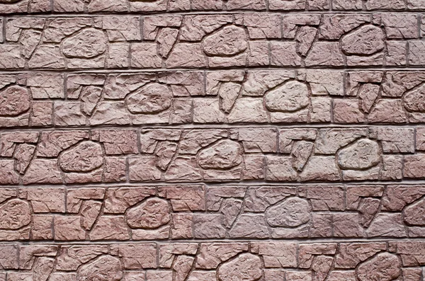 Red decorative relief plaster imitating stones on wall