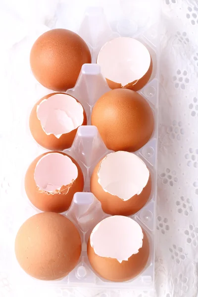 Chicken eggs shells on white lace background
