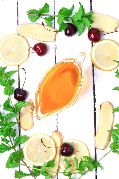 Ginger honey lemon mint cherry on a white wooden background ingredient for homemade lemonade rustic style flat look view from above over head