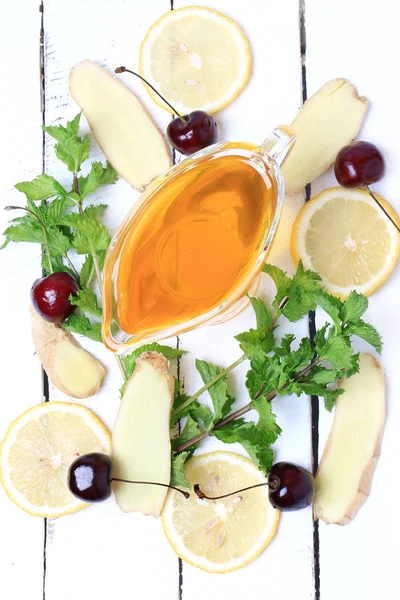 Ginger honey lemon mint cherry on a white wooden background ingredient for homemade lemonade rustic style flat look view from above over head