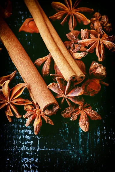 Anise and cinnamon spices on the old wooden background