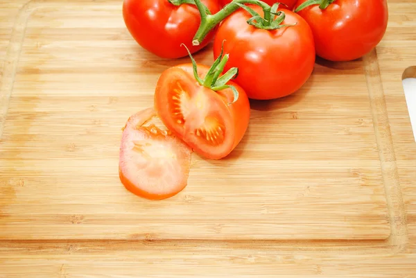Fresh Organic Tomatoes on a Wooden Cutting Board