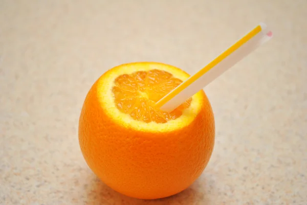 Straw in an Juicy Ripe Orange