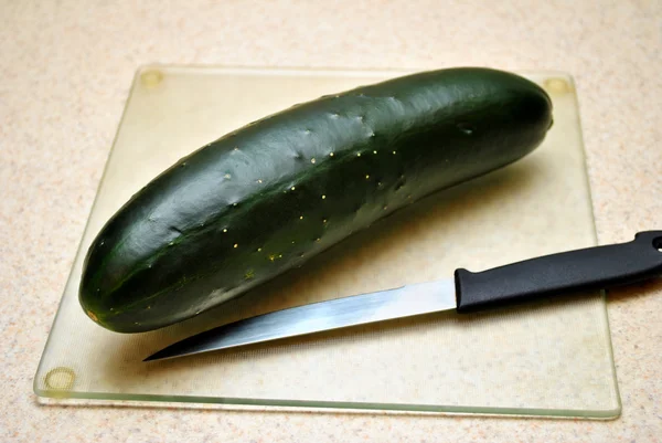 Whole Cucumber on a Glass Cutting Board