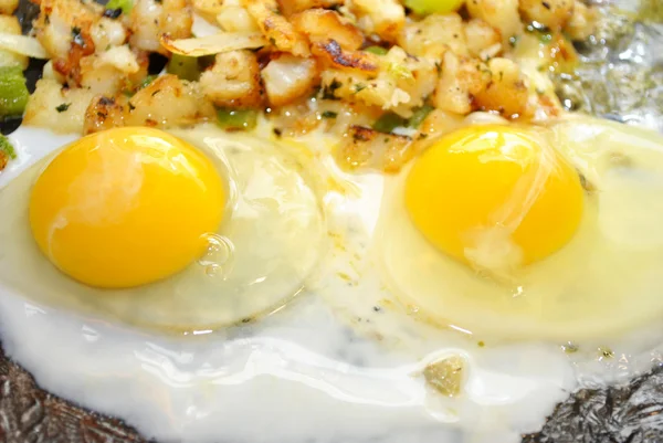 Two Over Easy Eggs Cooking in a Pan