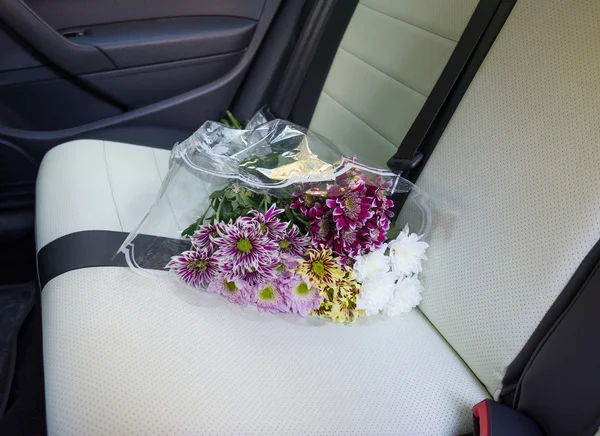 Dahlias bouquet on car rear seat