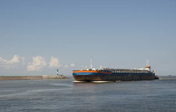 Barge with tugboat transporting sand