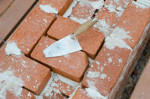 Mason bricklaying background with trowel and brick blocks