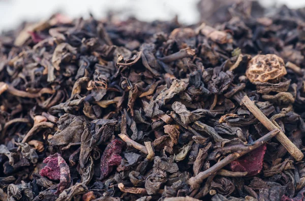Dried black tea leaves and fruits