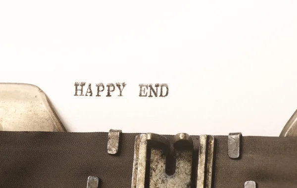 Words happy end  written on typewriter