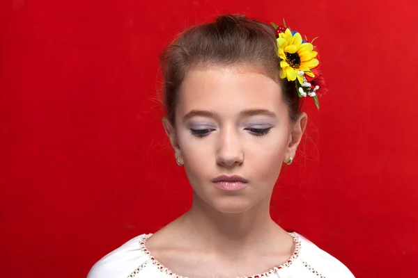 Girl with perfect makeup with flower in hair