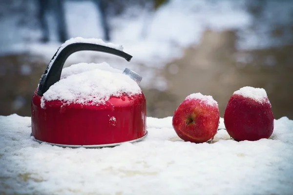 Red tea kettle and apples