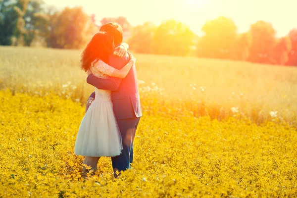 Just married couple hugging in the meadow