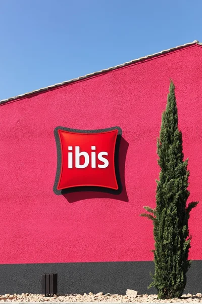 Ibis hotel sign on a red wall