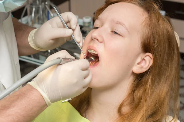 Girl in the dentist\'s chair with braces