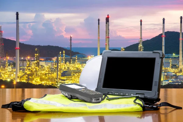 Smart factory - Rugged computers tablet in front of oil refinery