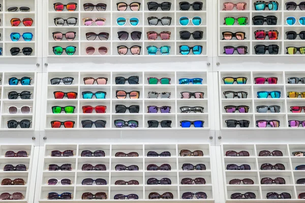 Sunglasses on sale display shelf in sunglasses shop at the city