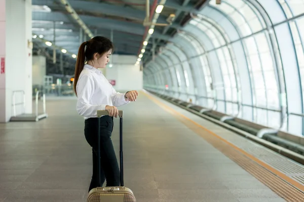 Business travel concept - Young Asian business woman looking in