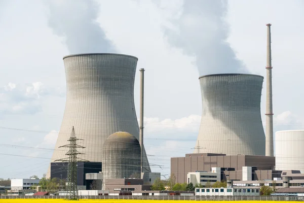 Nuclear power plant with yellow field and big blue clouds in Ger