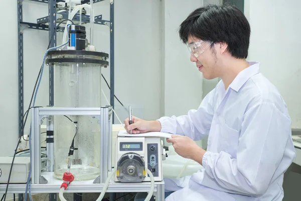 Scientist conducting research taking notes  in laboratory