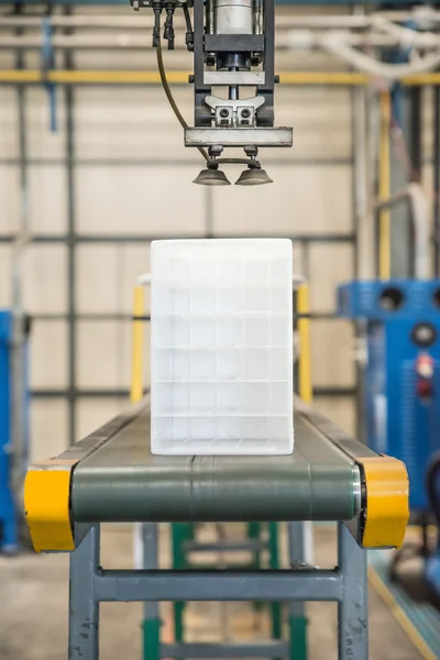 Industrial robot working in plastic factory