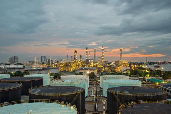 Oil refinery and storage tank at twilight