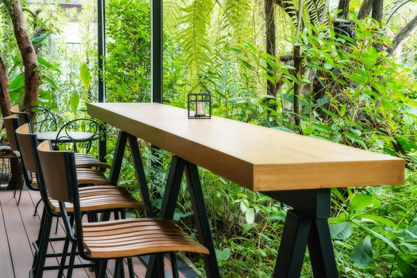 Coffee table and chair in the green garden.