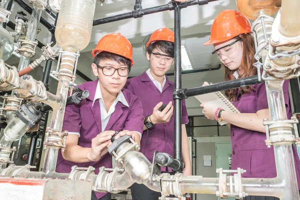 Engineer student turning pipeline pump for training in laborator
