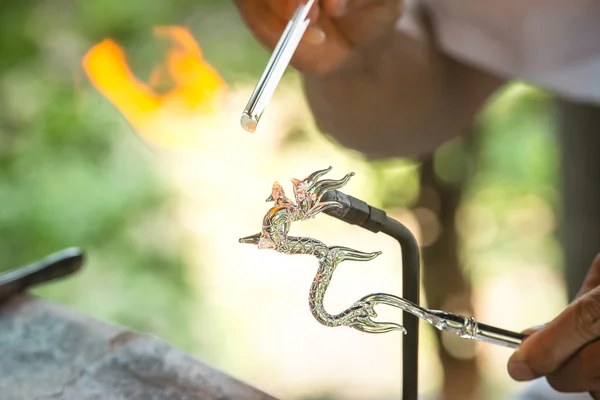 Blowing glass in a dragon shape