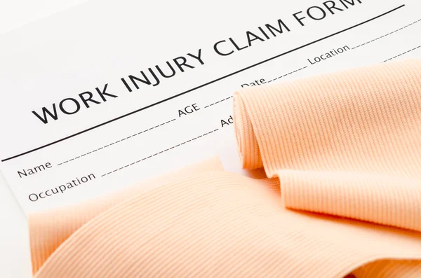 Work injury claim form showing business insurance concept.