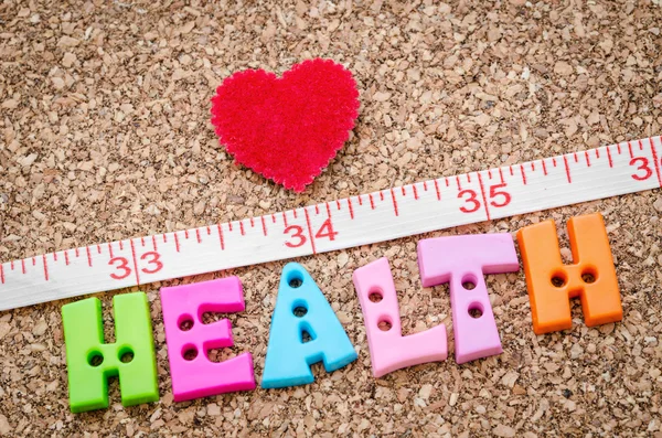 Measure and health word with red heart.