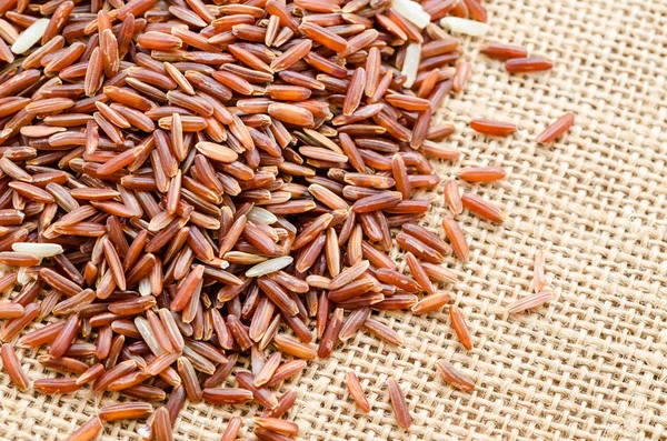Heap of red rice on burlap