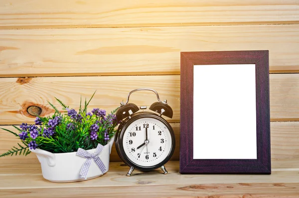Blank wood photo frame and alarm clock.