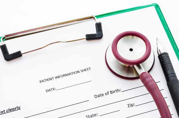 Blank Patient information on green clipboard with stethoscope.