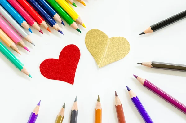 Color pencils and paper heart shape.